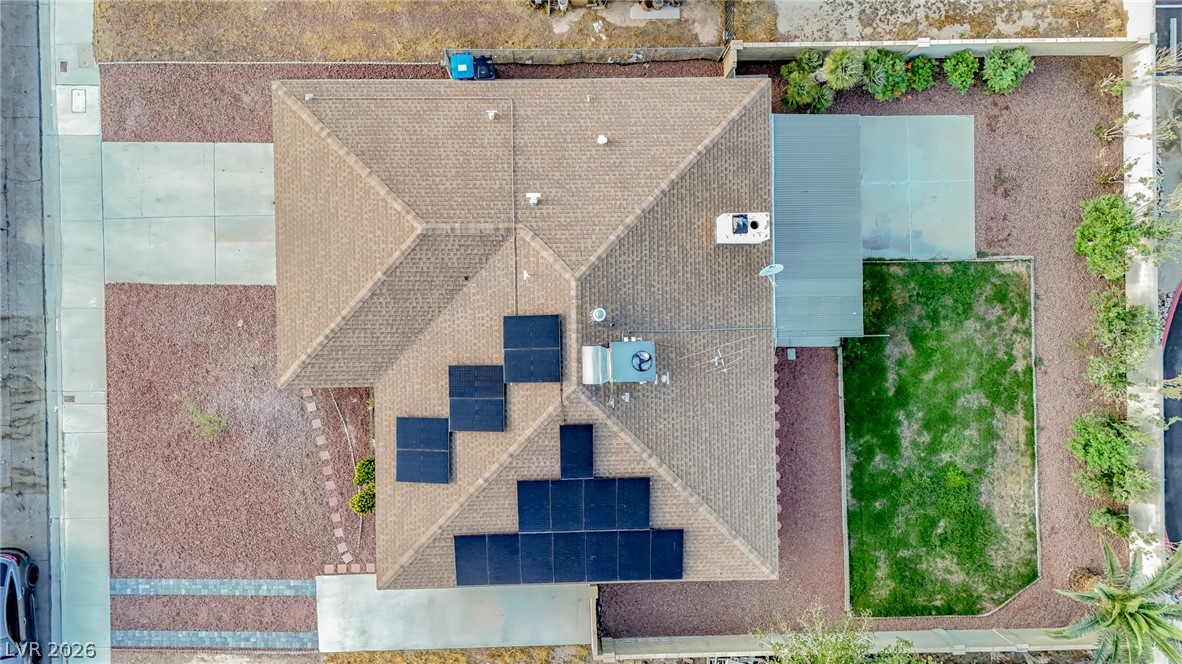 321 Lakehurst Road Las Vegas, NV 89145 - Photo 30 of 33 An aerial perspective showcases the shingle roof, integrated solar panels, and landscaped yard layout.