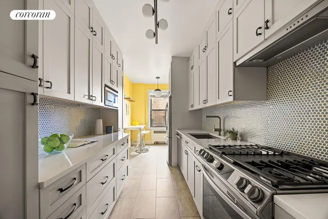 a view of a room with wooden floor and small bathroom