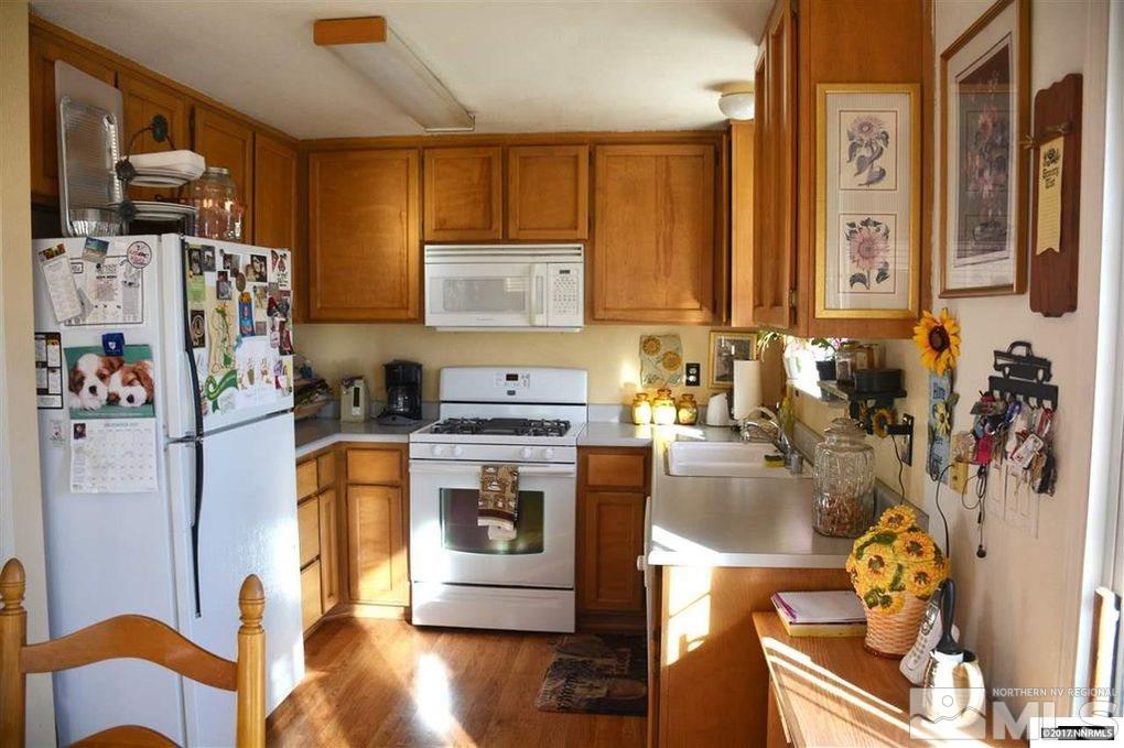 544 Yellow Jacket Road Dayton, NV 89403 - Photo 2 of 8 a kitchen with a refrigerator and a stove top oven