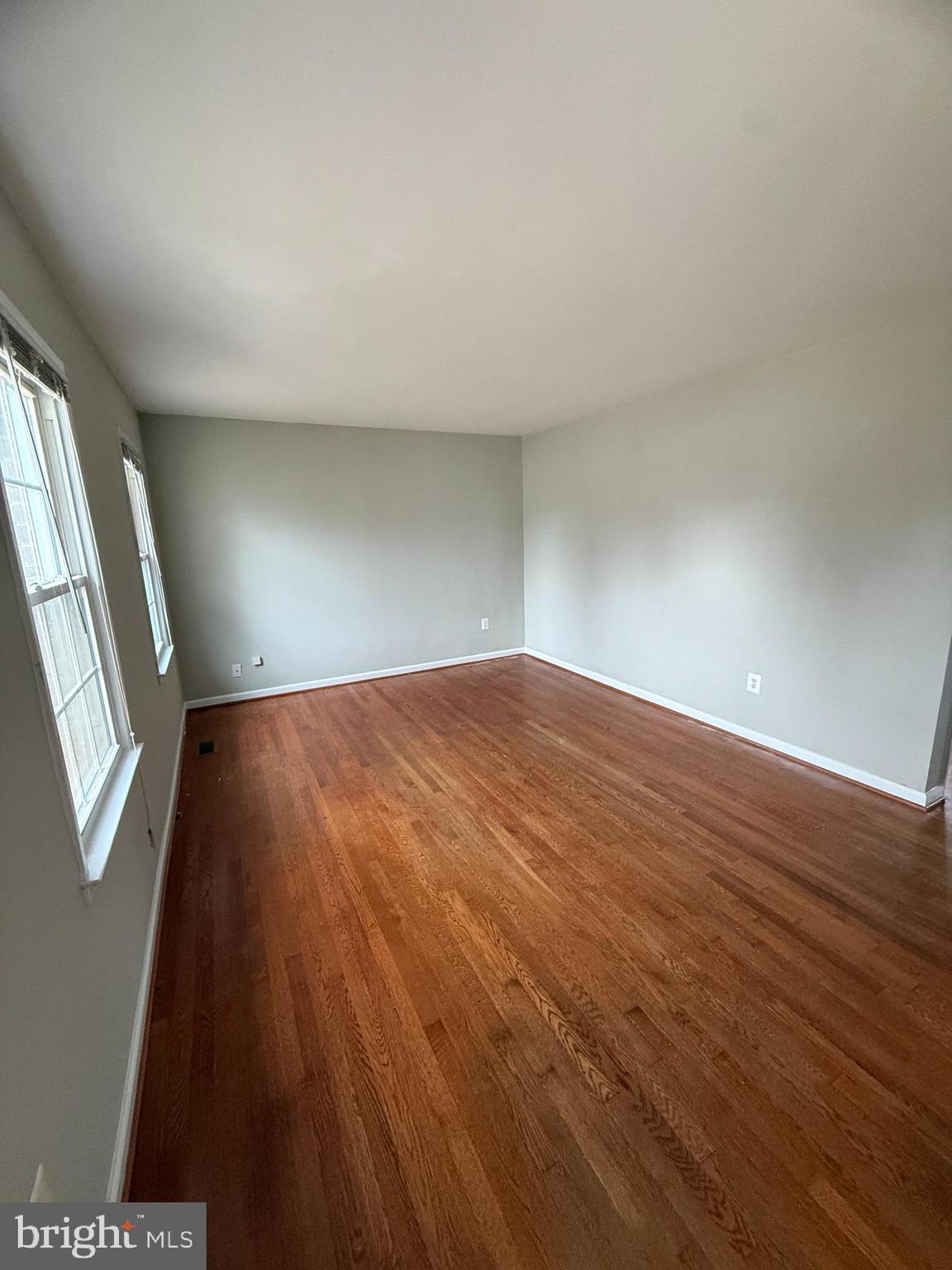 4542 Kingston Road Woodbridge, VA 22193 - Photo 2 of 15 an empty room with wooden floor and windows