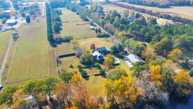 a front view of house with yard and trees in the background