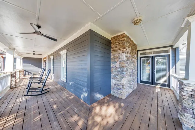 a living room with a large window and furniture