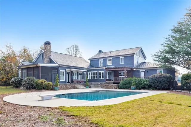 a living room with furniture a wooden floor and a sink