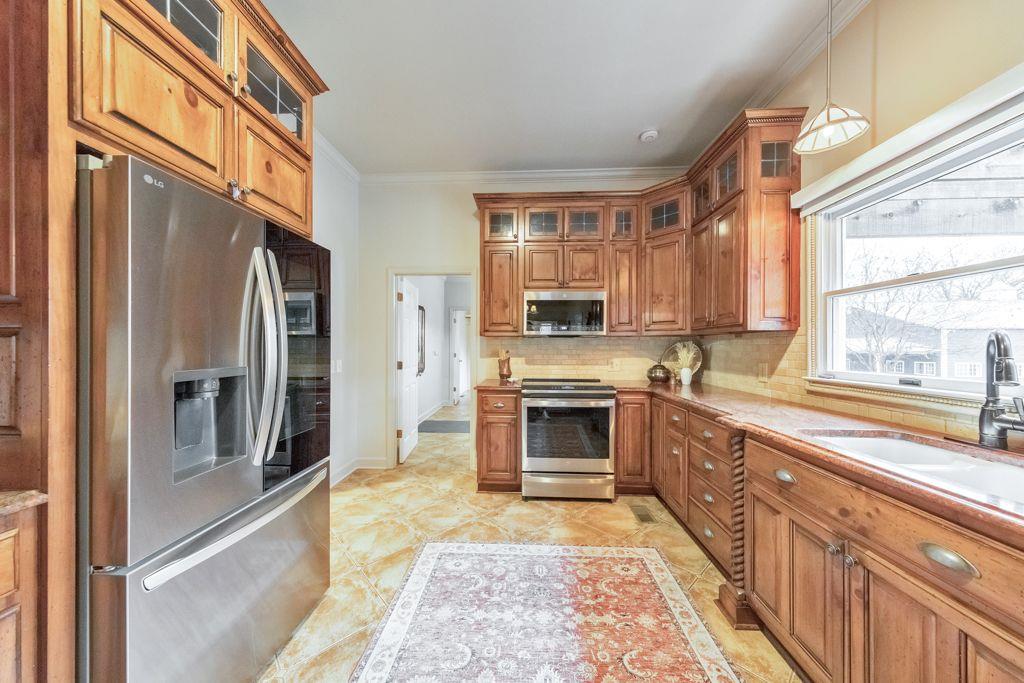 528 Old Alabama Road Southeast Cartersville, GA 30120 - Photo 22 of 101 a kitchen with stainless steel appliances granite countertop a refrigerator a stove and a sink with wooden floor