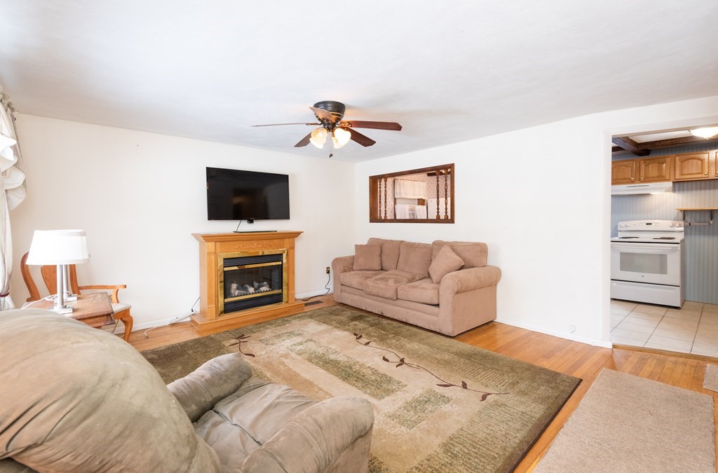 7 Robinson Road Beverly, MA 01915 - Photo 14 of 27 a living room with furniture and a fireplace