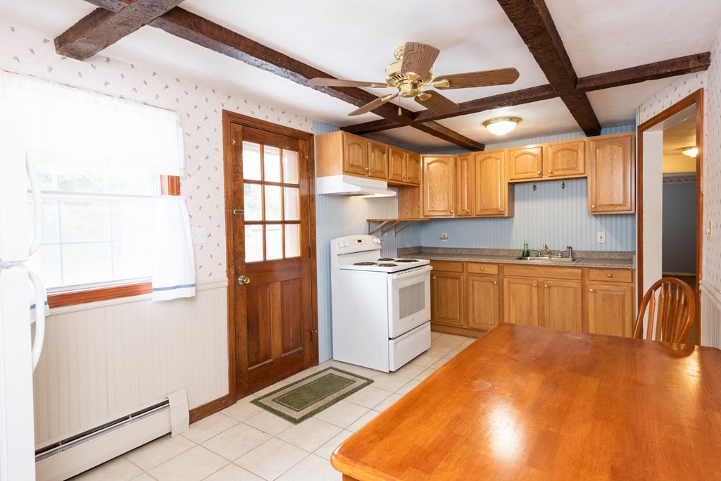 7 Robinson Road Beverly, MA 01915 - Photo 16 of 27 a kitchen with white cabinets and white appliances