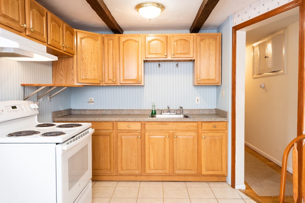 7 Robinson Road Beverly, MA 01915 - Photo 18 of 27 a kitchen with granite countertop cabinets stainless steel appliances and a counter space