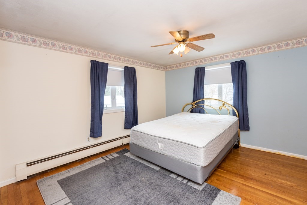 7 Robinson Road Beverly, MA 01915 - Photo 19 of 27 a bedroom with a bed and a large window