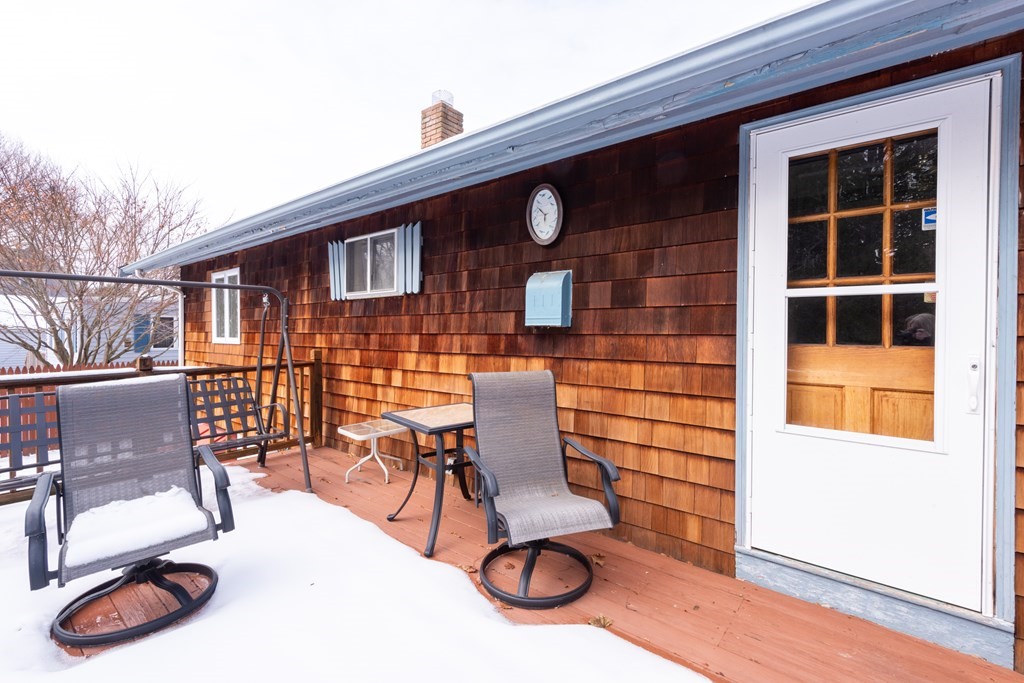 7 Robinson Road Beverly, MA 01915 - Photo 6 of 27 a view of a patio with table and chairs with wooden floor and fence
