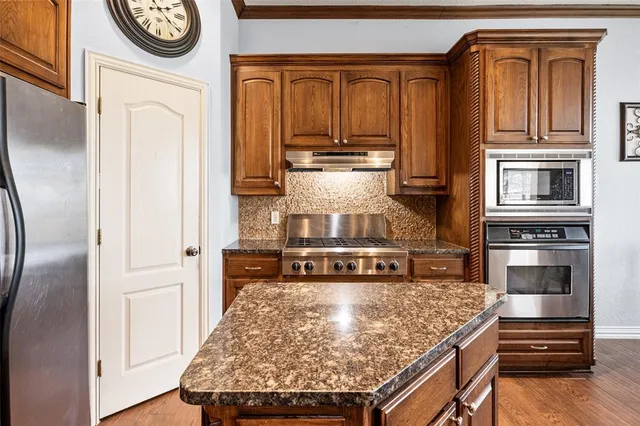 a large kitchen with lots of counter and chairs