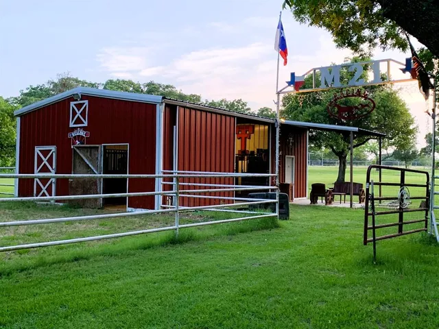 a view of green field with grass and a fence
