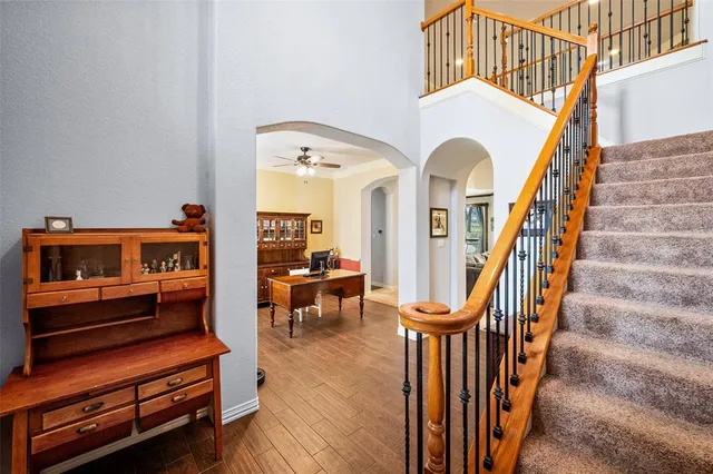 a dining room with wooden floor and chandelier