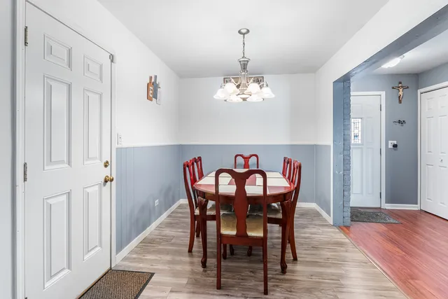 a view of a dining room with furniture wooden floor and chandelier
