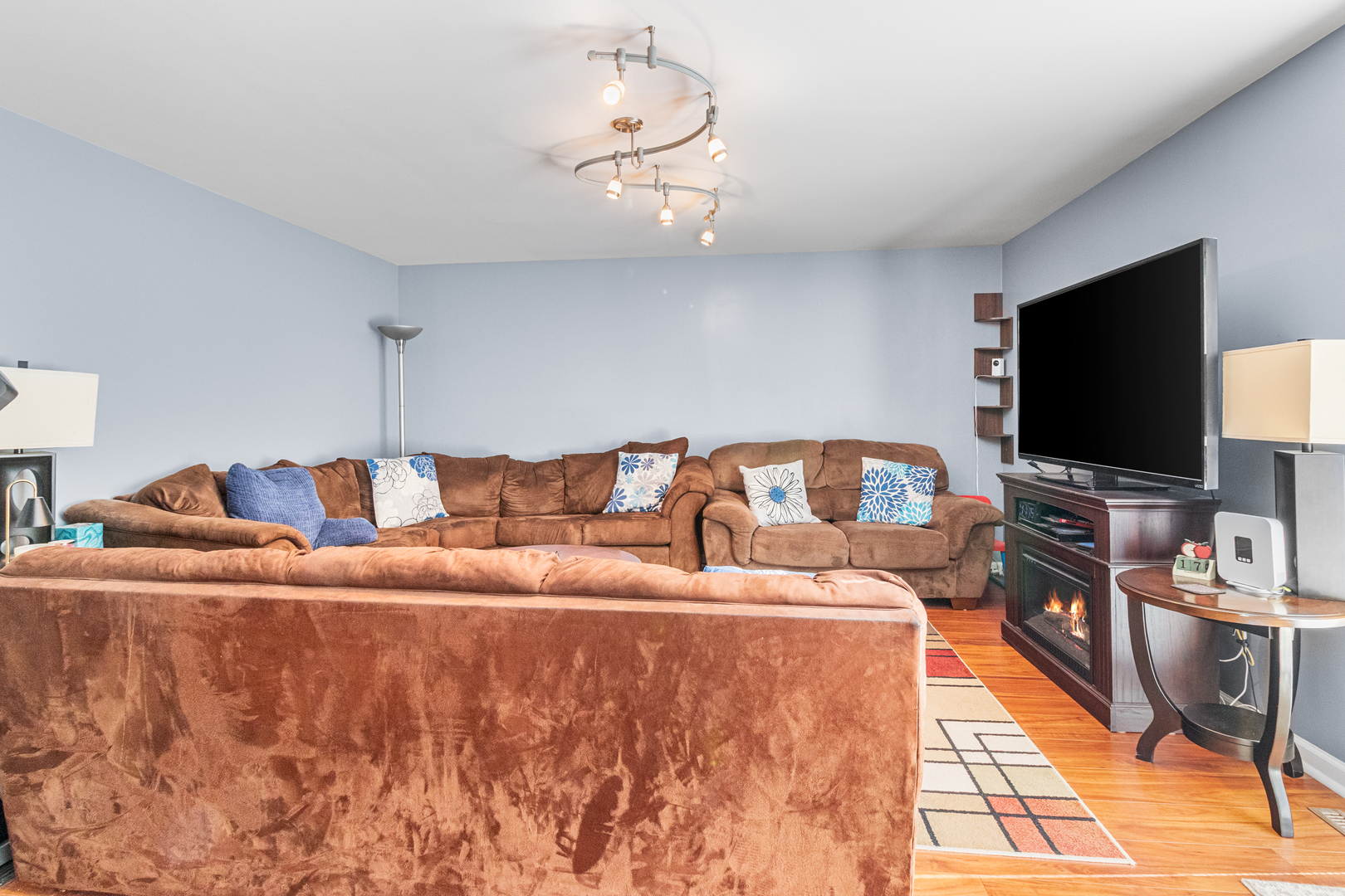 379 Stone Place Wheeling, IL 60090 - Photo 18 of 27 a living room with a couch and a flat screen tv