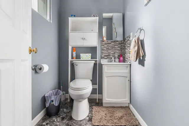 a bathroom with a toilet and a shower curtain