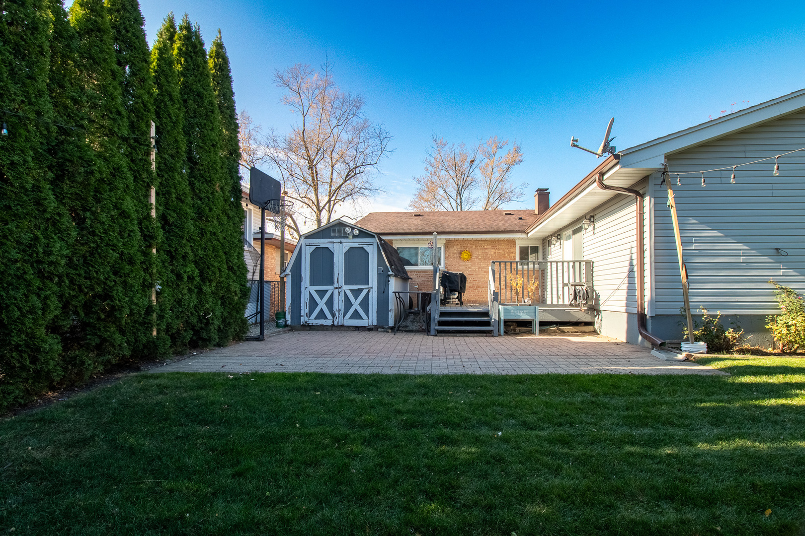 379 Stone Place Wheeling, IL 60090 - Photo 25 of 27 a patio with table and chairs with plants and wooden fence