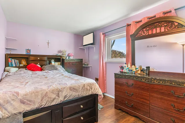 a bedroom with a bed and a dresser