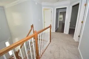 a view of a hallway with stairs