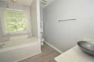 a bathroom with a tub and a shower