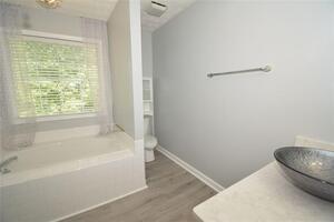 1740 Big Haynes Court Southwest Grayson, GA 30017 - Photo 16 of 29 a bathroom with a tub and a shower