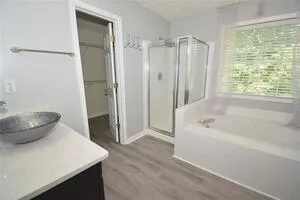 a bathroom with a sink a toilet a tub and shower