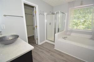 1740 Big Haynes Court Southwest Grayson, GA 30017 - Photo 18 of 29 a bathroom with a sink a toilet a tub and shower