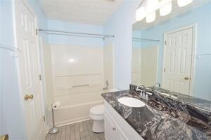 1740 Big Haynes Court Southwest Grayson, GA 30017 - Photo 20 of 29 a bathroom with a granite countertop sink toilet and shower