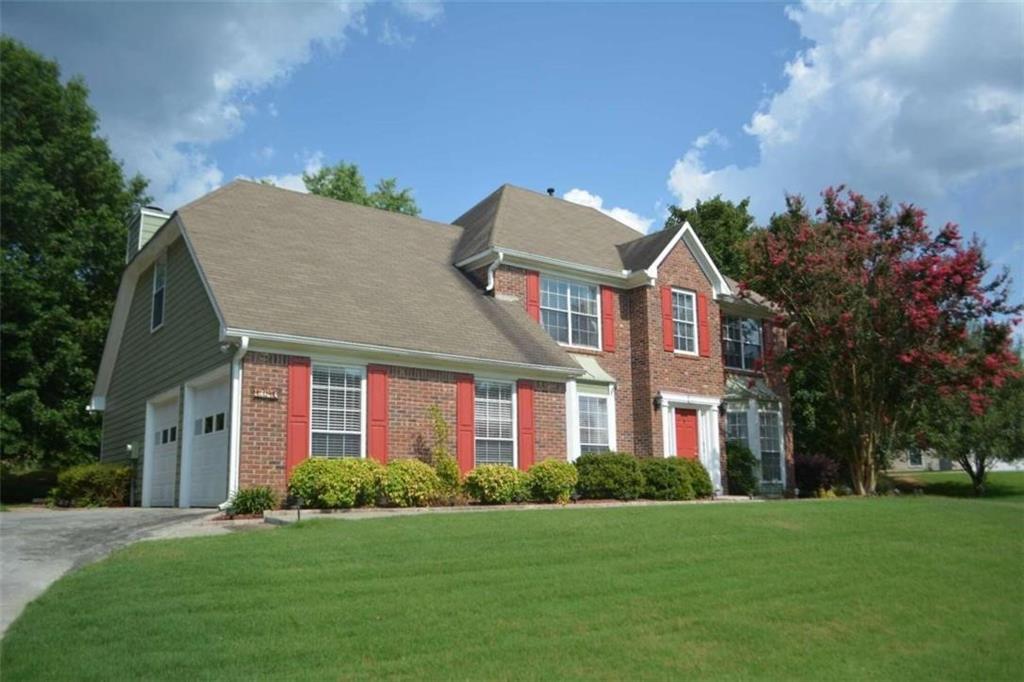 1740 Big Haynes Court Southwest Grayson, GA 30017 - Photo 2 of 29 a front view of a house with a yard and trees