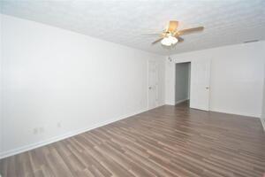 1740 Big Haynes Court Southwest Grayson, GA 30017 - Photo 6 of 29 a view of a room with wooden floor and a ceiling fan