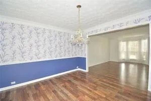 a view of a room with window and wooden floor