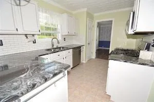 a kitchen with stainless steel appliances granite countertop a sink stove and cabinets