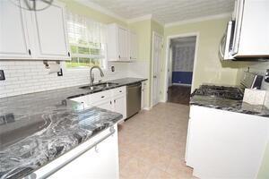 1740 Big Haynes Court Southwest Grayson, GA 30017 - Photo 10 of 29 a kitchen with stainless steel appliances granite countertop a sink stove and cabinets