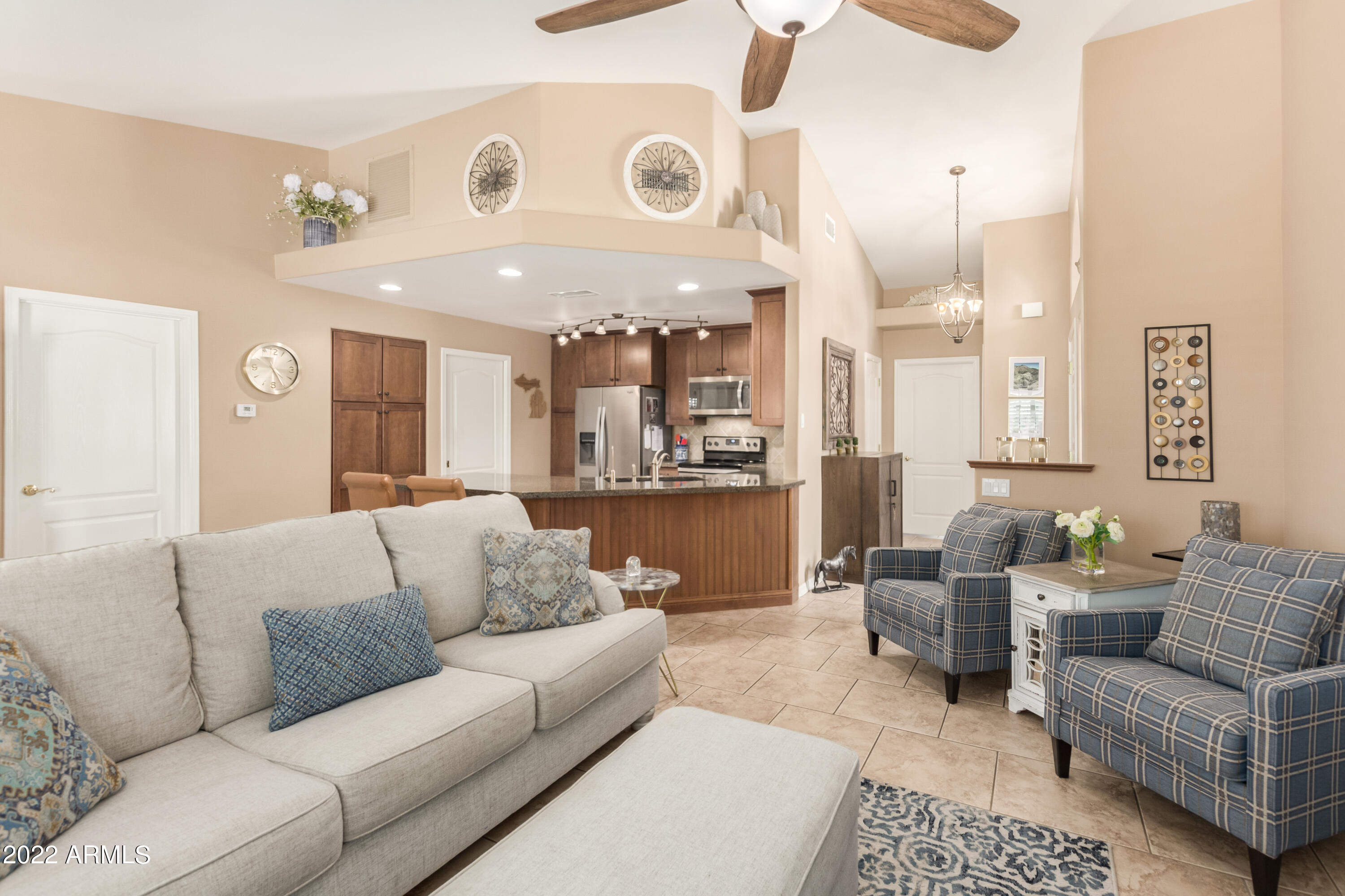 5830 East McKellips Road, Unit 76 Mesa, AZ 85215 - Photo 12 of 33 a living room with furniture and kitchen view