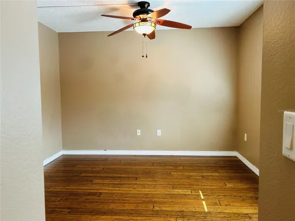 a view of a room with wooden floor