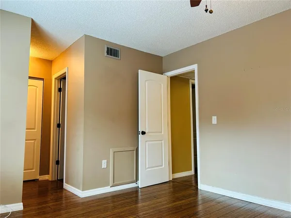 a view of a hallway with wooden floor