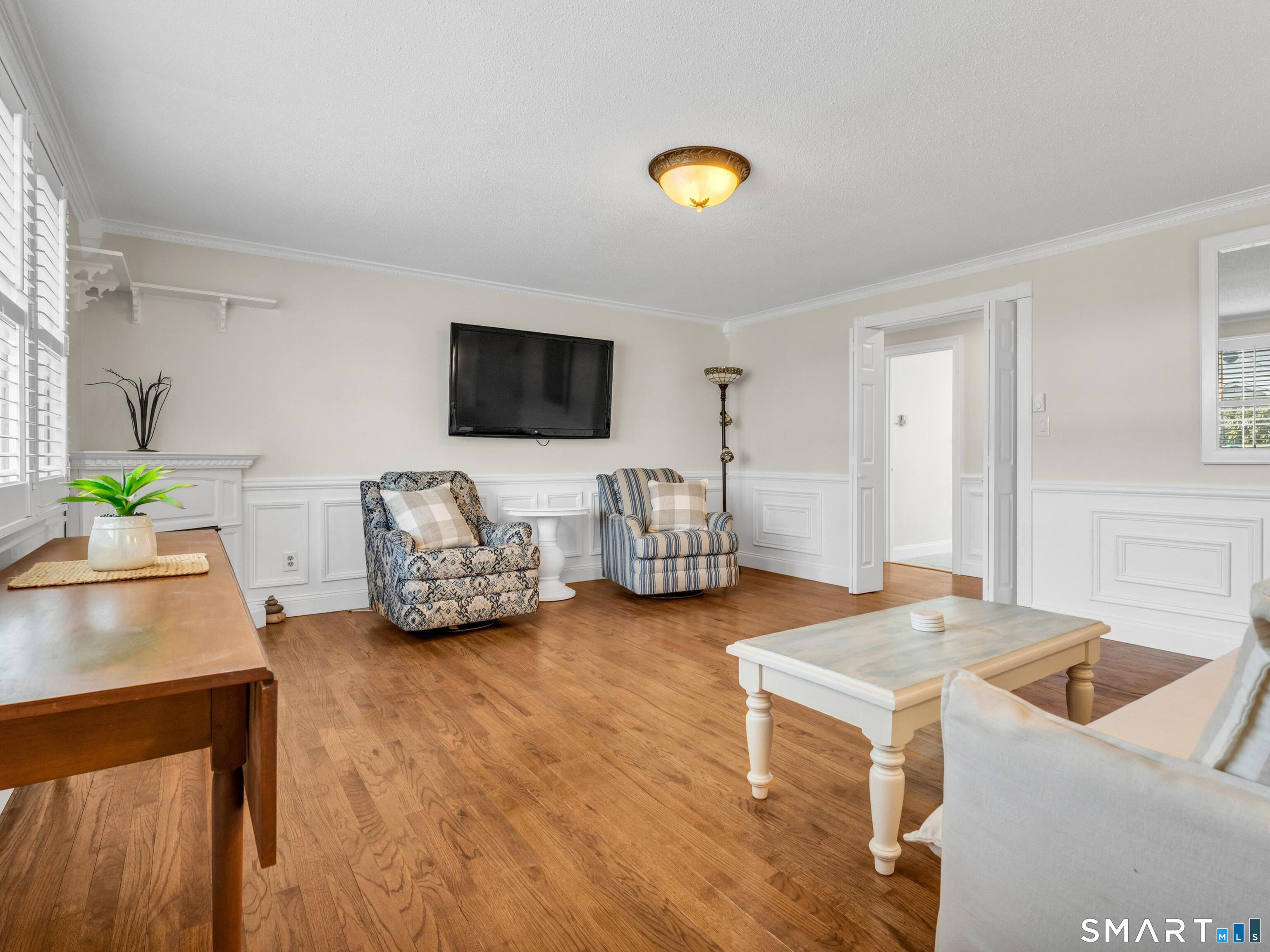 280 East Main Street, Unit B5 Clinton, CT 06413 - Photo 6 of 19 Such a bright and cozy room with molding detail and hardwood flooring.