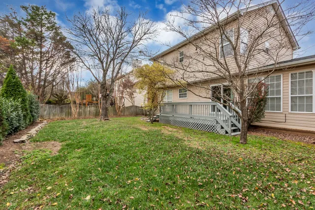 a view of a tree in front of a house