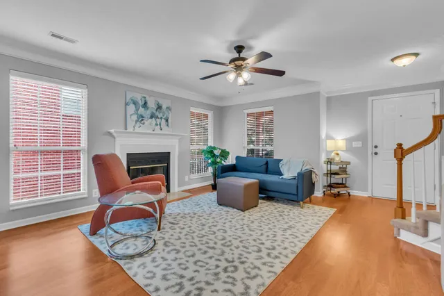 a living room with furniture a fireplace and a window