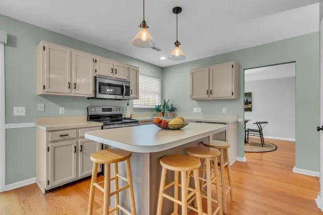 a kitchen with stainless steel appliances stove microwave and cabinets
