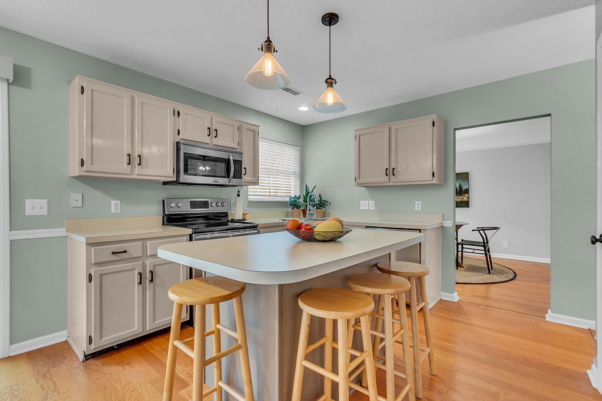 505 Hollyhock Way Franklin, TN 37064 - Photo 8 of 28 a kitchen with stainless steel appliances stove microwave and cabinets