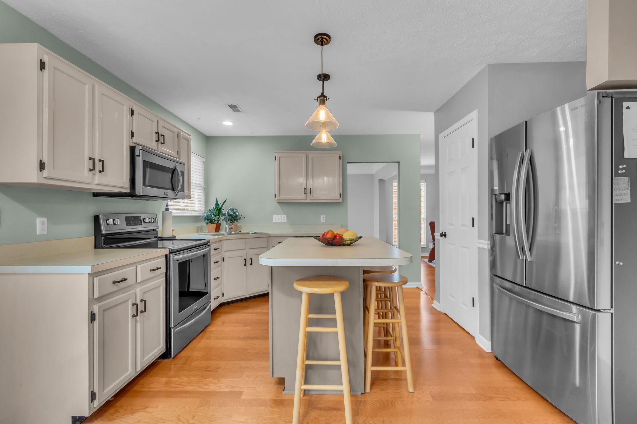 505 Hollyhock Way Franklin, TN 37064 - Photo 9 of 28 a kitchen with stainless steel appliances granite countertop a stove refrigerator and a sink