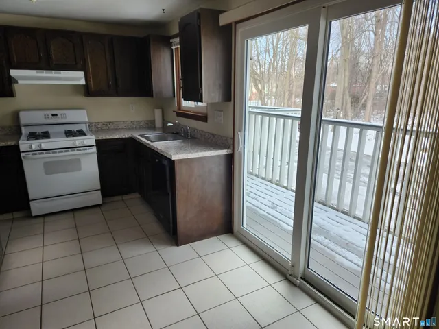 a kitchen with a sink a stove and a refrigerator