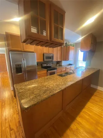 a view of a kitchen with a sink and cabinets