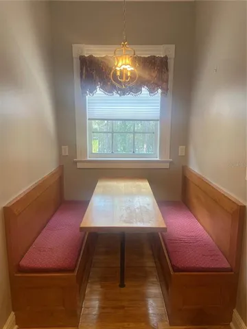 a room with pool table and a window