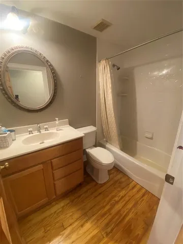 a bathroom with a sink mirror vanity and toilet
