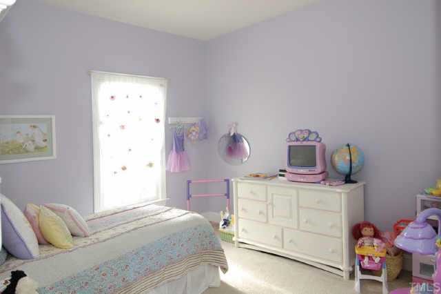 5017 Denham Court Raleigh, NC 27613 - Photo 7 of 11 a bedroom with a bed and dresser