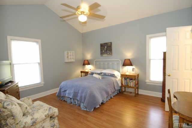5017 Denham Court Raleigh, NC 27613 - Photo 8 of 11 a bedroom with a bed and a window