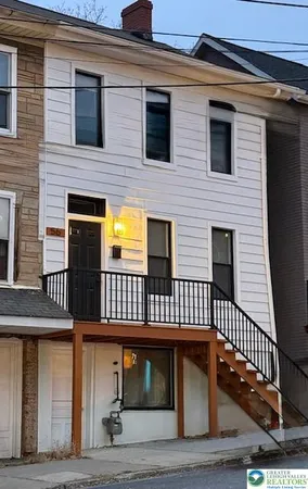a view of a house with wooden deck front door