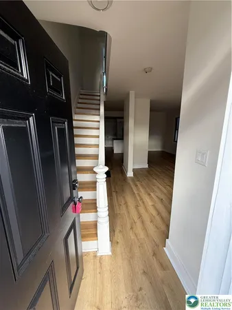 a view of a hallway view with wooden floor and staircase