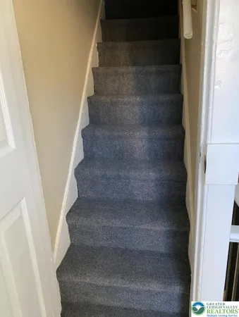 a view of staircase with white walls